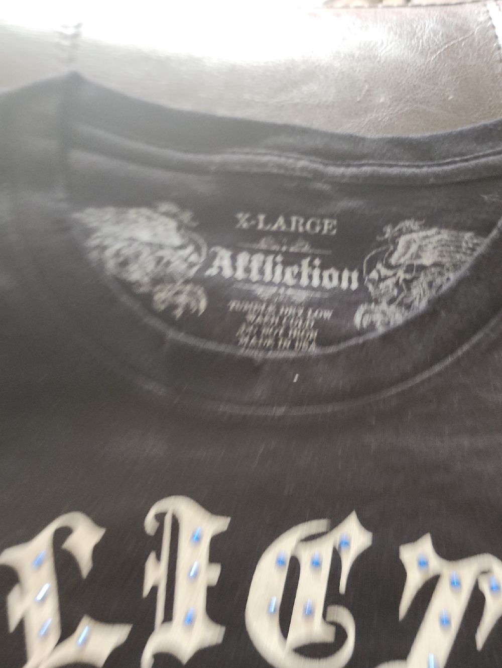 Affliction Black Men's Graphic Tee with Cream Gothic Letters and Blue Studs
